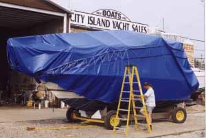 man tarping boat
