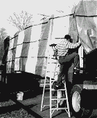 guy tarping a truck